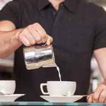 barista pouring milk