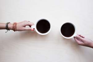 white-coffee-flatlay-background-hands-hold-cup-mug